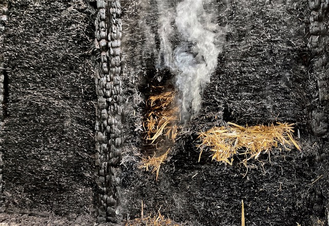 A charcoal layer protecting the inner layers of straw